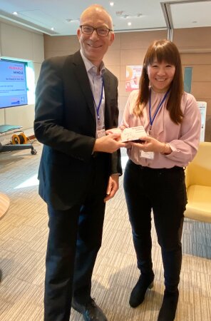 (left) Professor Coombs receives a souvenir from (right) Professor Cheung (Director of the HKBU Research Office).