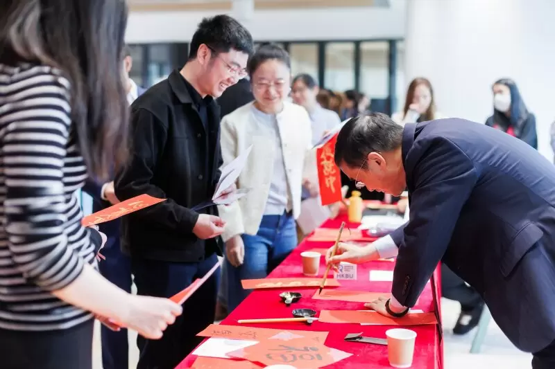 Attendees at the calligraphy booth