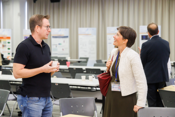 The discussion continues as participants mingle after the formal session, including Professor Jos Bartels in conversation with Professor Carolin Plewa, Adelaide University