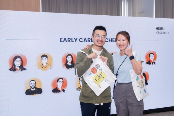 Researchers engage with interactive activities at the fun booth, designing their own tote bags and luggage tags.